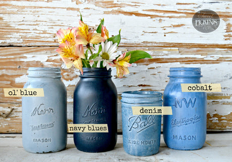 Set of four mason jars painted Navy Blues with Old Fashioned Milk Paint; one jar holds flowers.
