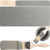 Paintbrush with Newell Fusion Mineral Paint alongside paint swatches displaying color coverage and texture.