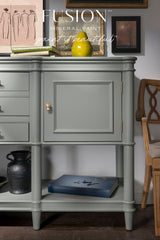 Sage Green Newell Fusion Mineral Paint sideboard with black vase, framed art, and branded cabinet text.