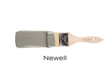 Paintbrush with bristles coated in Newell Fusion Mineral Paint, shown lying flat.