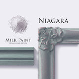 Homestead House Niagara Green Milk Paint powder with “Niagara” text beside ornate white frame corner.