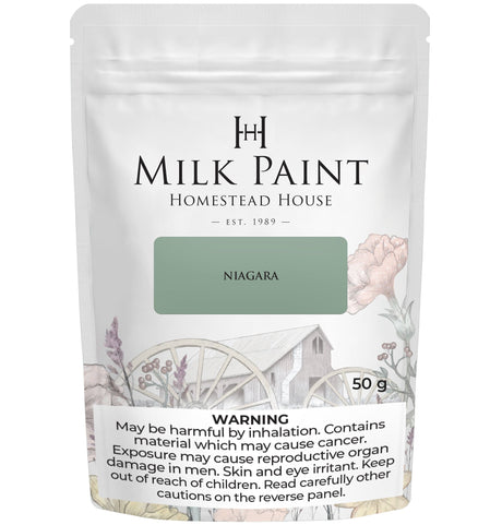 Homestead House Niagara Green Milk Paint 50g bag with floral design and visible cancer risk warning.