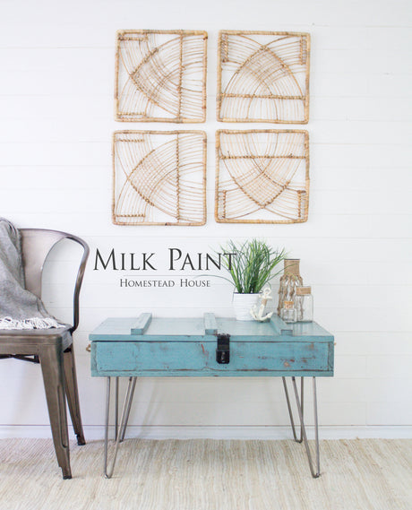 Table painted with Niagara Green Milk Paint by Homestead House placed beside a metal chair.