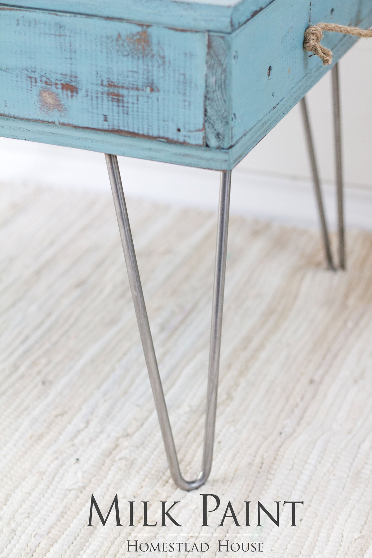 Blue-green wooden table with metal hairpin legs, finished in Homestead House Niagara Green Milk Paint.