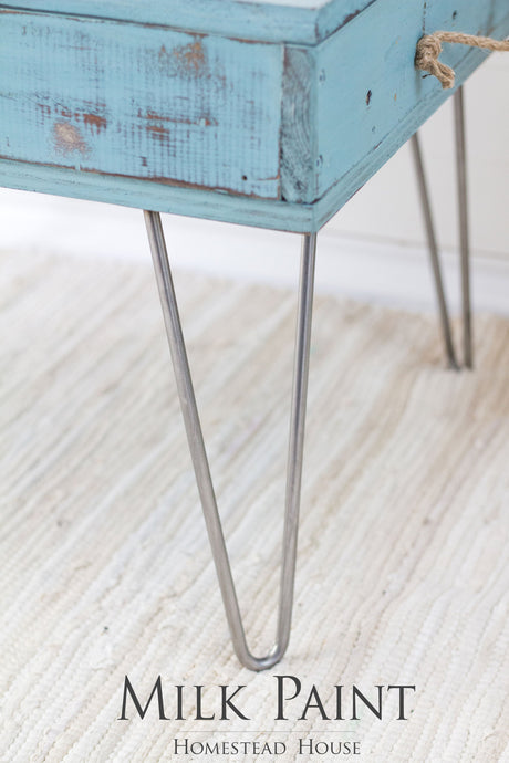 Blue-green wooden table with metal hairpin legs, finished in Homestead House Niagara Green Milk Paint.