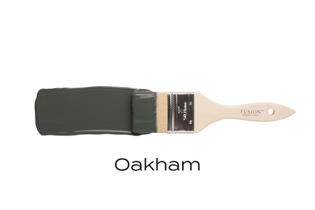 Brush with Oakham Fusion Mineral Paint (matte, dark green) against a white background.