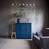 Blue cabinet painted in Ocean Alchemy by Fusion Mineral Paint with a stool nearby.