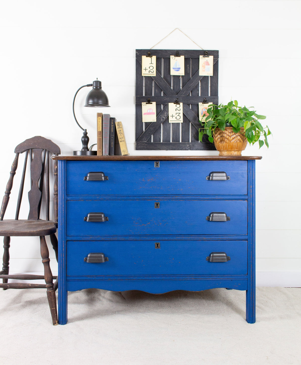 Three-drawer dresser in Ocean Milk Paint by Homestead House, with plant and lamp on top.