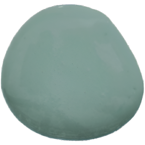 Pale green stone painted with Ocean by Old Fashioned Milk Paint on a white background.