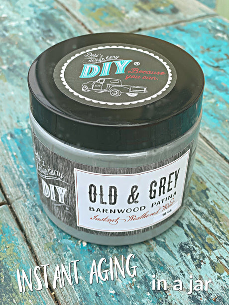 DIY Paint Co. Old & Grey Barnwood Liquid Patina jar on blue wooden surface.