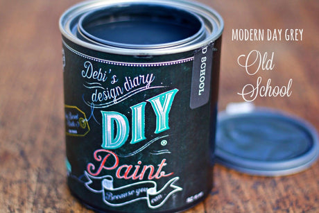 Open can of Old School DIY Paint by DIY Paint Co., Modern Day Grey, eco-friendly, with lid nearby.