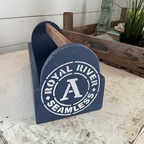 Blue wooden caddy painted with Pacific DIY Cottage Color by DIY Paint Co., shown on a table.