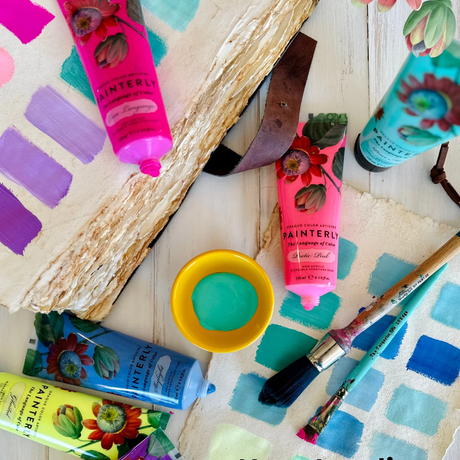 Painterly Blendable Furniture Artist Paint by DIY Paint Co., four tubes with brush, palette, and swatches on table.