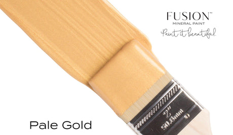 Fusion Mineral Paint Pale Gold Metallic paint jar with visible product label and a paintbrush featuring the paint.
