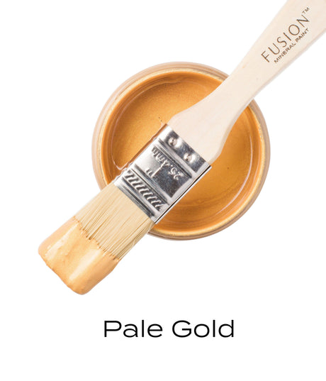 Paintbrush with Pale Gold Metallic rests on open jar of Fusion Mineral Paint in Pale Gold Metallic.