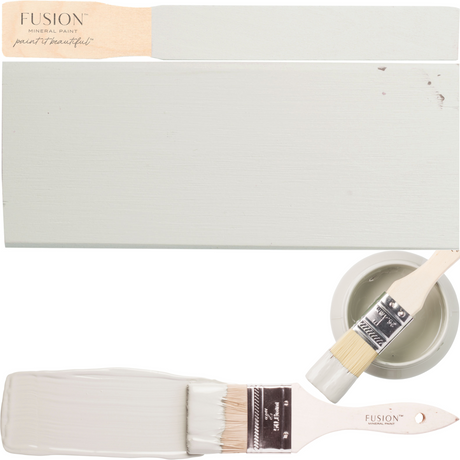 Parchment Fusion Mineral Paint swatch with stir stick, two brushes, and a paint bowl.
