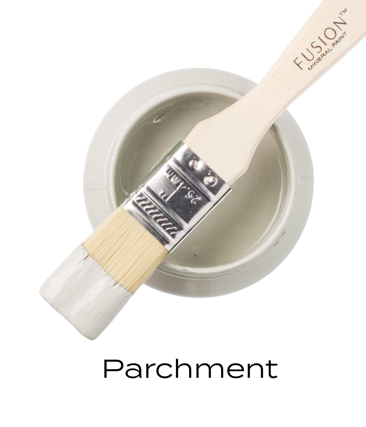 Paintbrush with white Fusion Mineral Paint rests on open jar of Parchment by Fusion Mineral Paint.