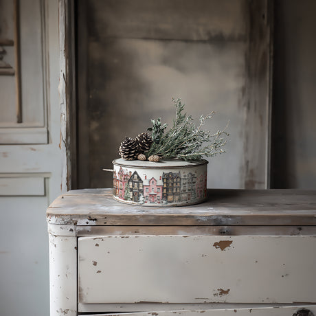Partridge Lane Transfer (2025 Limited Release) by I.O.D. on round tin with winter houses, shown on white dresser.