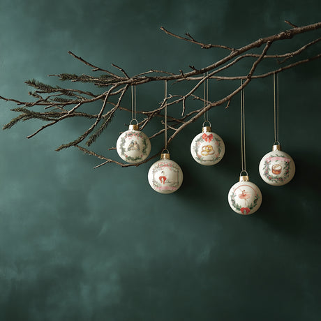 Five ornaments with I.O.D. Partridge Lane Transfer (2025 Limited Release) displayed on a bare branch, green background.