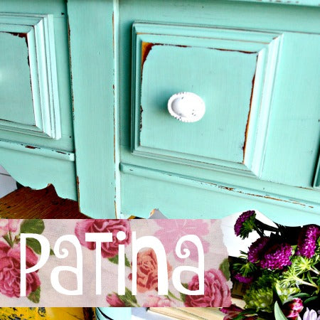 Turquoise cabinet painted with Patina – Sweet Pickins Milk Paint, white knob, and floral fabric detailing.