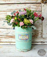 Assorted flowers in a Patina-painted vintage bucket by Old Fashioned Milk Paint.
