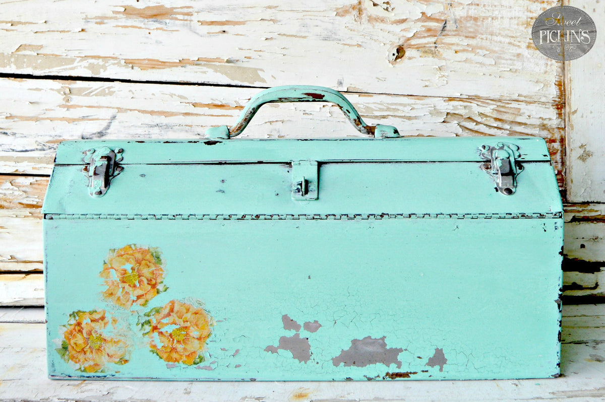 Vintage toolbox painted Patina by Old Fashioned Milk Paint displayed against a distressed wood background.