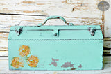 Vintage toolbox painted Patina by Old Fashioned Milk Paint displayed against a distressed wood background.