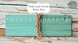 Sweet Pickins Milk Paint wood trim sample by Old Fashioned Milk Paint, showing dark-waxed and unwaxed sections with twine.