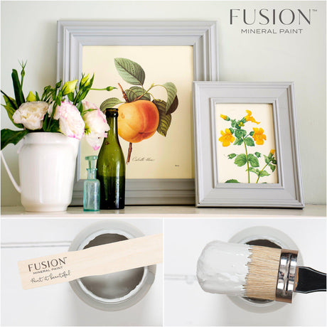 Framed art, flowers, bottles, and Fusion Mineral Paint Pebble displayed on a shelf.