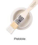 Brush resting on Pebble Fusion Mineral Paint jar, showing smooth matte finish.