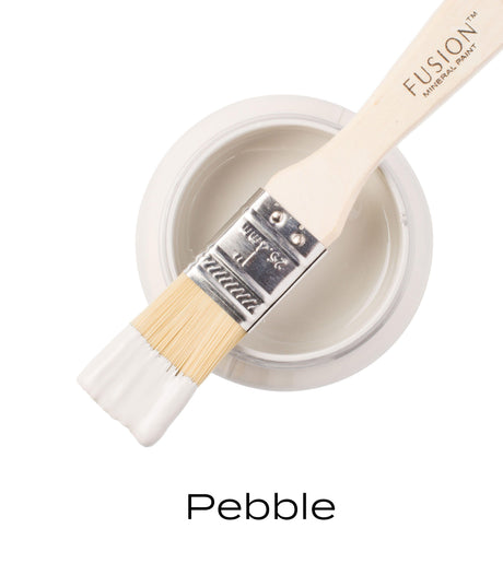 Brush resting on Pebble Fusion Mineral Paint jar, showing smooth matte finish.