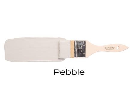 Paintbrush with Pebble Fusion Mineral Paint by Fusion Mineral Paint against a white background.