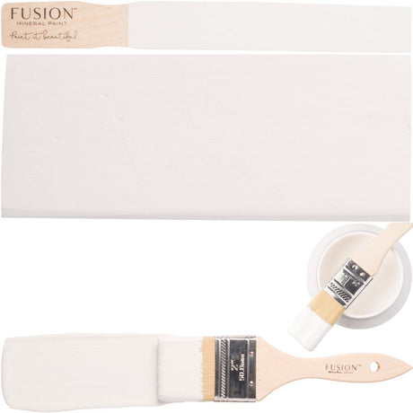 Paintbrush, painted wood strip, and bowl of Fusion Mineral Paint Picket Fence displayed together.