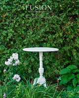 Pure white round table finished in Picket Fence Fusion Mineral Paint by Fusion Mineral Paint, shown outdoors.
