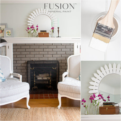 Fireplace painted in Picket Fence Fusion Mineral Paint, with a sunburst mirror, flowers, and striped chairs.