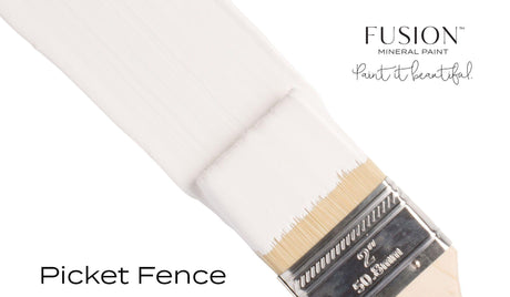 Brush with white Picket Fence Fusion Mineral Paint on bristles, shown with branding on a white background.