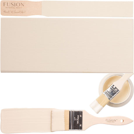 Cream board and brush with an open jar of Fusion Mineral Paint in the Plaster color on display.