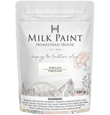 Homestead House Porcelain Milk Paint 330g bag with floral art, wagon wheel graphic, and warning label.