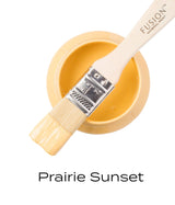 Open jar of Prairie Sunset Fusion Mineral Paint with a brush resting inside, showing the paint’s matte finish.