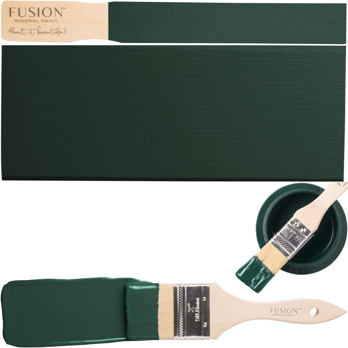 Brush with green paint next to a swatch and open Fusion Mineral Paint Pressed Fern container.