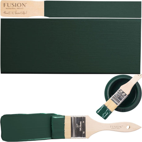 Brush with green paint next to a swatch and open Fusion Mineral Paint Pressed Fern container.