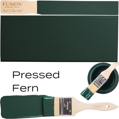 Paintbrush with dark green paint, color swatch, and Pressed Fern Fusion Mineral Paint label shown together.