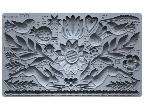 Primitive Mould by IOD, gray silicone mold with floral, leaf, rabbit, and bird designs labeled with volume and weight.