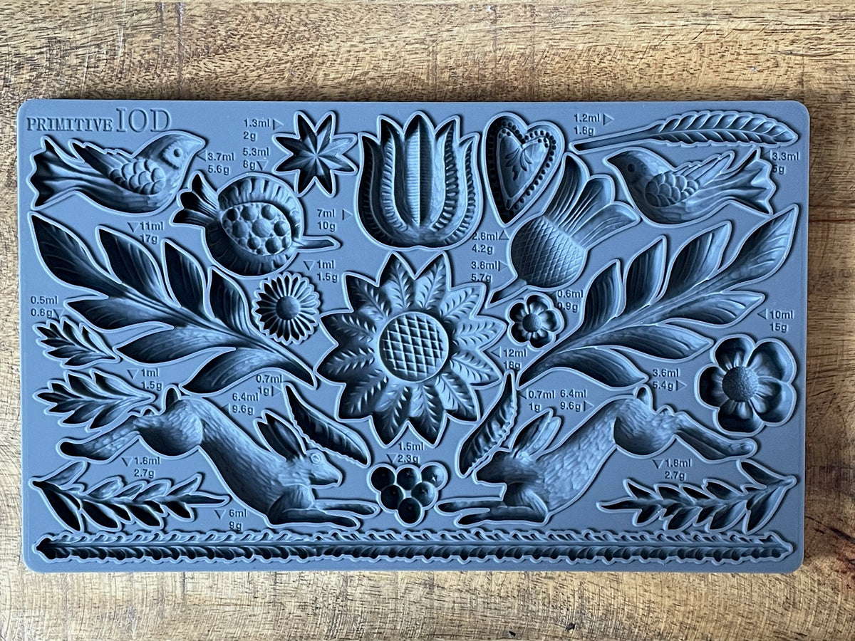Primitive Mould by IOD, gray silicone mold featuring floral, bird, fruit, and rabbit shapes.