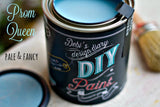 Can of Prom Queen DIY Paint by DIY Paint Co., pale blue, with brush and lid resting alongside.