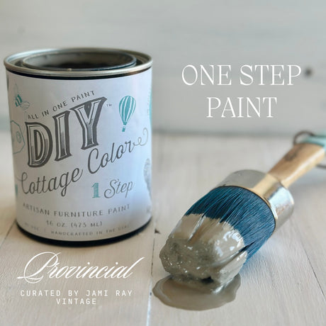 Open can of Provincial DIY Cottage Color by DIY Paint Co. with gray brush on light wood surface.