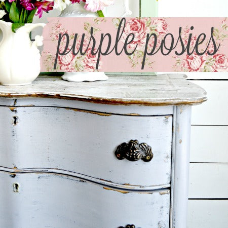 White pitcher with flowers on a distressed dresser painted Purple Posies by Old Fashioned Milk Paint.
