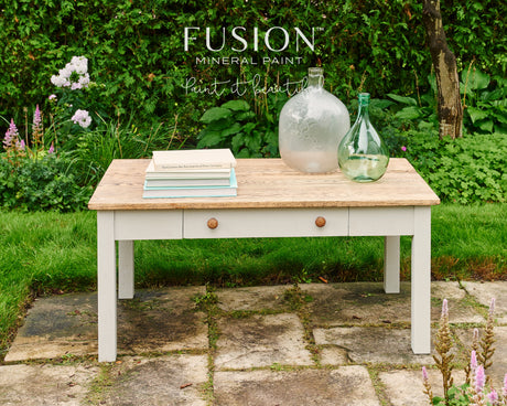 Books painted with Fusion Mineral Paint in Putty displayed on a matte wooden table.