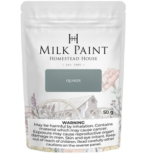 Quaker Blue Milk Paint by Homestead House, 50g bag, with floral design and warning label on the package.