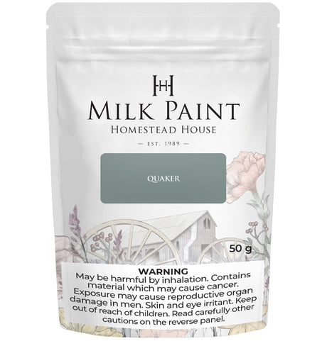 Quaker Blue Milk Paint by Homestead House, 50g bag, with floral design and warning label on the package.